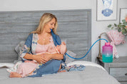 Mom breastfeeding her daughter while drinking water from her EasyJug Water Bottle