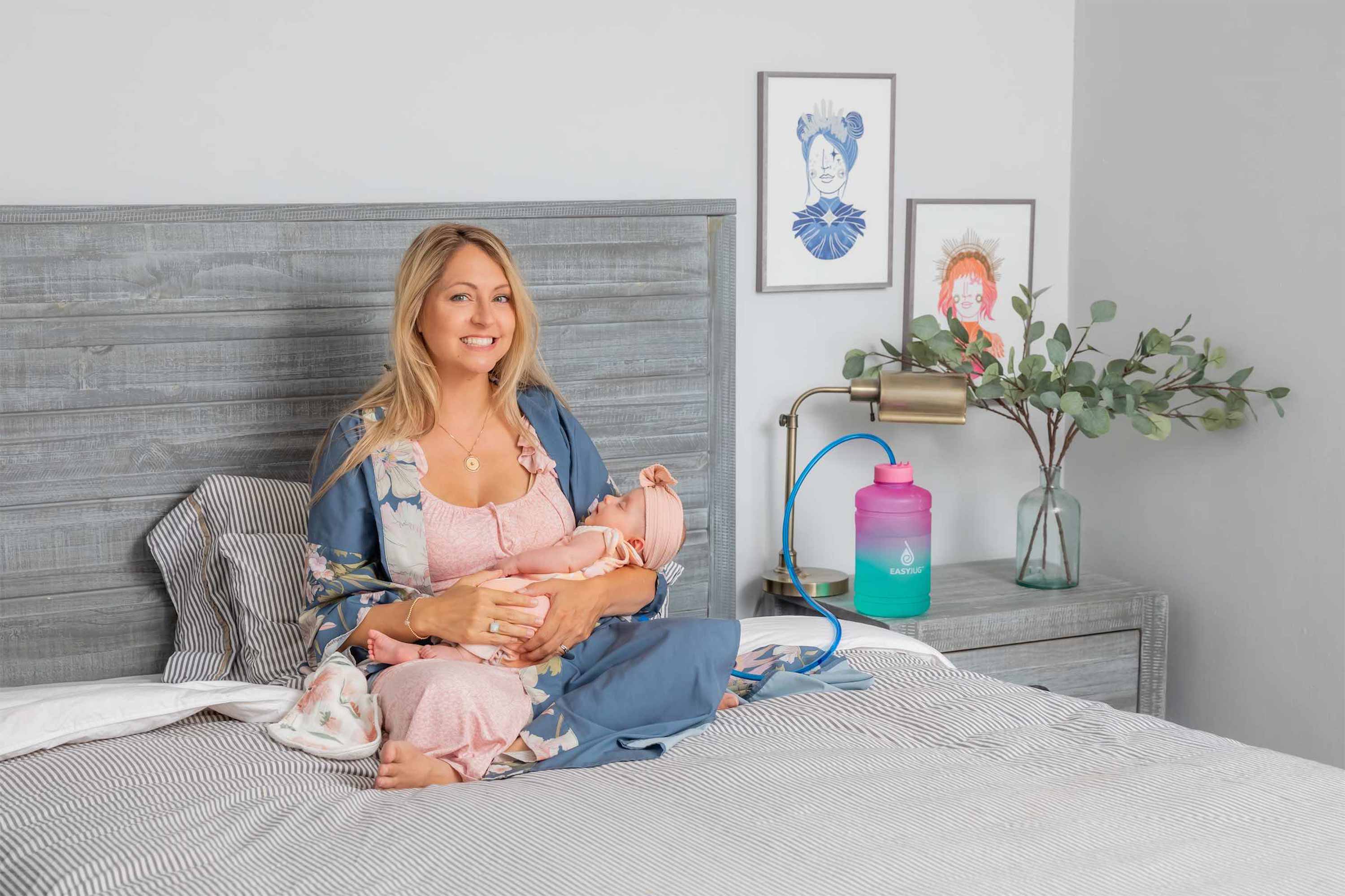 Breastfeeding Mom with Baby in Bed next to her EasyJug Breastfeeding Water Bottle
