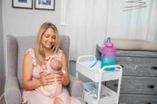 Breastfeeding Mom playing with her Baby in Nursery Room with her EasyJug Water Bottle